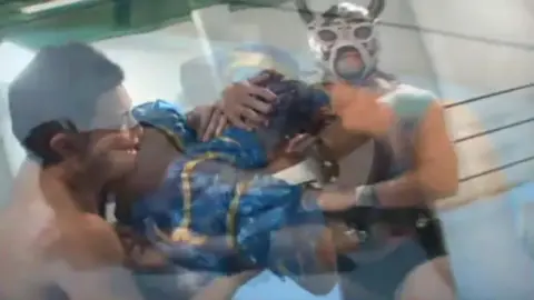 Asian Wrestlers Grapple in Ring