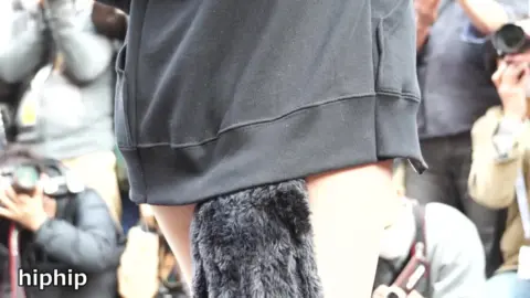 Asian Girl in White Bodysuit at Outdoor Event