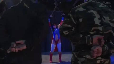 Asian superheroine bound and restrained