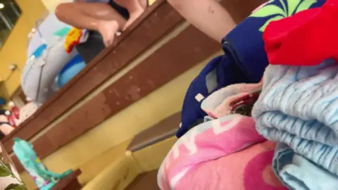 Wet Female in Swimsuit Bending Over