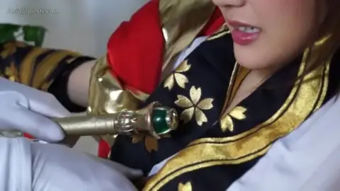 Asian Girl in Red Costume with Sword