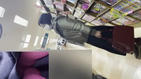 Asian Couple Kissing in Bookstore