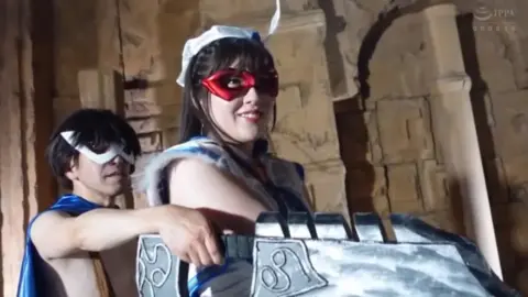 Asian Cosplay Models Pose with Weapons