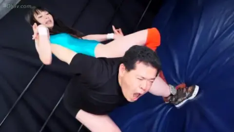 Asian Wrestlers Engage in Intense Matches