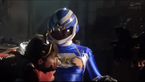 Asian Couple in Cosplay Embrace Intimately
