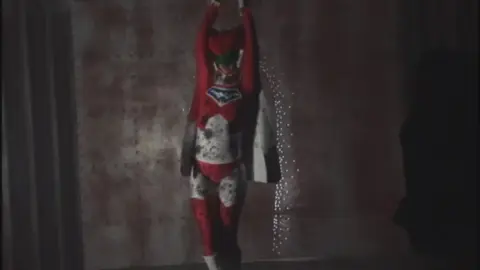 Asian Performer in Red and White Costume