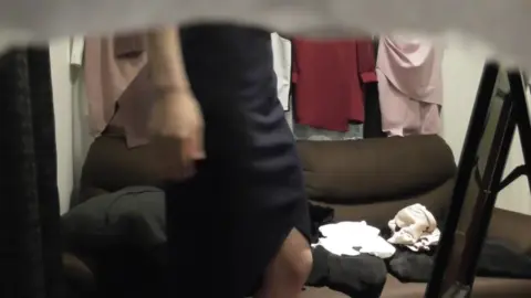 Asian Girl Changing Clothes in Bedroom