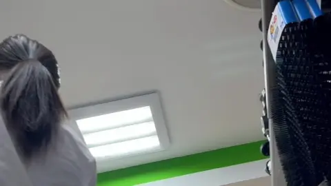 Asian Woman in Store Aisle