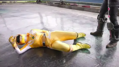 Asian Girls in Costumes Fighting in Industrial Area