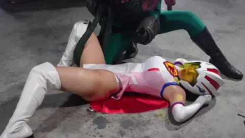 Asian Superheroine Wrestles Monster in Dark Room