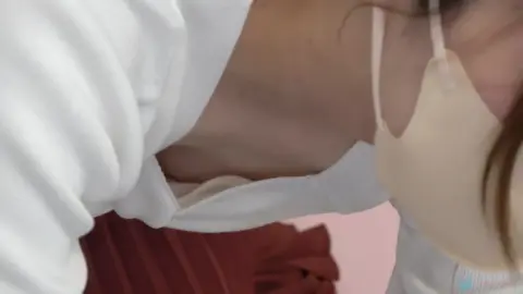 Asian Beauty Undresses in Bedroom