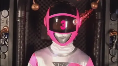 Blonde in Pink Bodysuit with Silver Accents in Industrial Setting