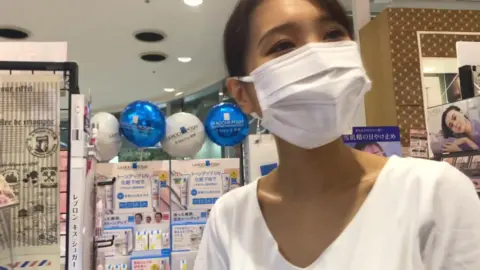 Woman in Mask Standing and Posing