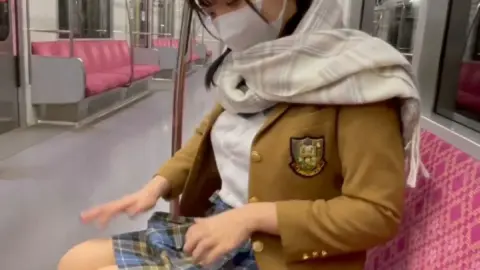 Asian Teen with Braids on Train