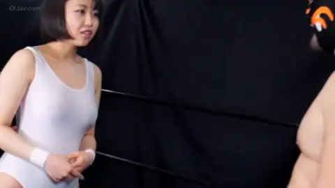 Asian Couple Engaged in BDSM Play