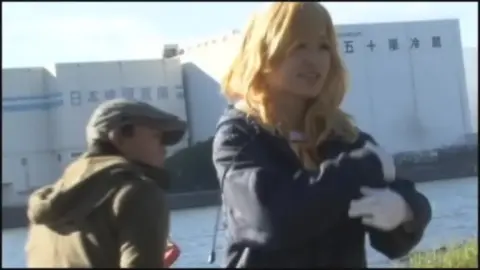 Cosplay Duo Engage in Playful Wrestling by Waterfront