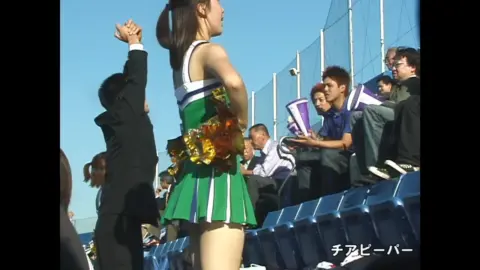 Asian Cheerleader in Green Uniform