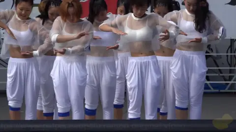 Asian Girls Dance in White Outfits on Stage