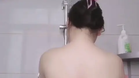 Asian Brunette in Pink Hair Clips Bathroom Shower