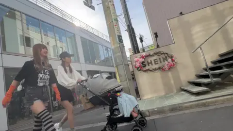 Asian Women in Striped Tights on City Street