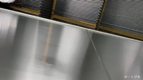 Asian Girl on Escalator