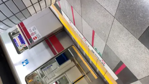 Asian Girl in Denim Shorts on Subway Platform