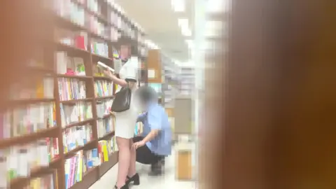 Asian Couple Intimate Moments in Library