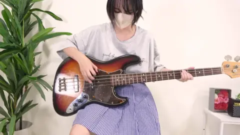 Asian Girl Playing Bass Guitar