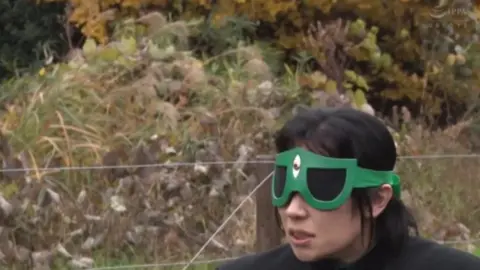 Asian Performers in Fetish Gear Engage in Intimate Acts