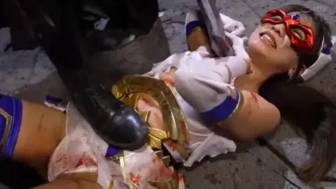 Asian Performer in Costume with Chains and Mask