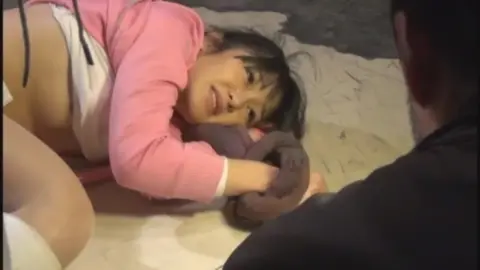 Asian Teen Plays with Ribbon Outdoors