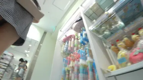 Asian Girl in Checkered Dress Shopping