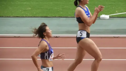 Asian Athletes Running Indoor Track