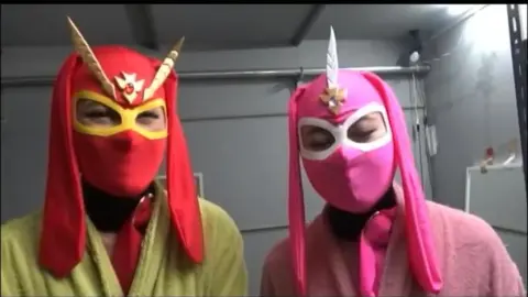 Asian Performers in Colorful Masks and Costumes