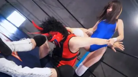 Asian Couple Engaged in Wrestling Match