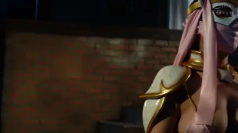 Asian Performers in Pink Costumes Engage in Dramatic Scenes