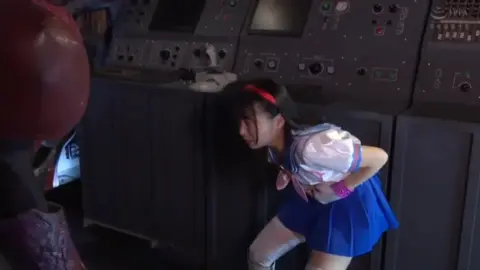 Asian Couple in BDSM Scene with Whipping and Restraint