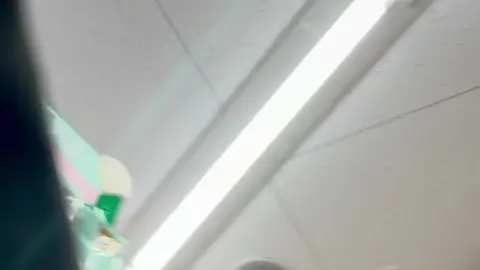 Asian Teen in Plaid Skirt Tease in Store