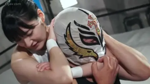 Asian Wrestlers Grapple in Ring
