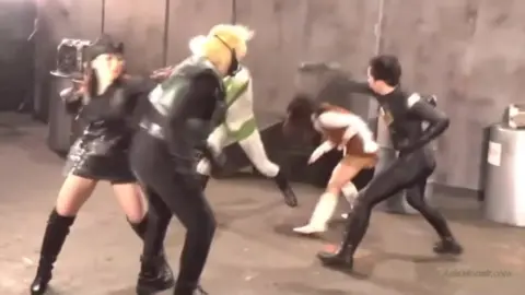 Asian Women in Leather Outfits and Masks