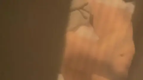 Blonde Masturbates in Dimly Lit Bedroom