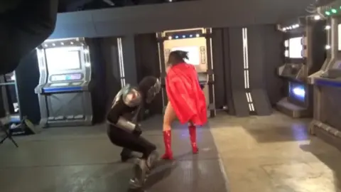Asian Wrestlers in Red Boots Engage in Intense Match