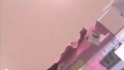 Blonde Woman Undressing in Dressing Room