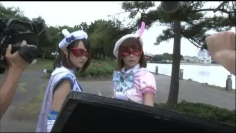 Asian Girls in Costumes by Waterfront