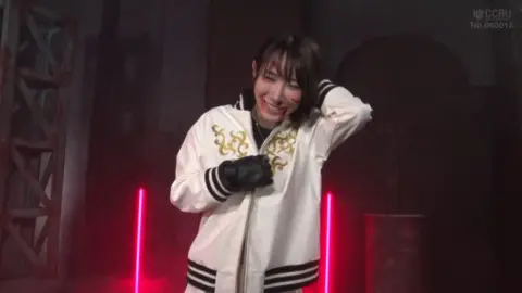 Asian Teen Performs on Stage with Sword