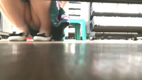 Slim Caucasian Girl in Video Game Store