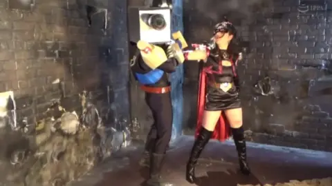 Asian Cosplay Duo in Dramatic Indoor Setting