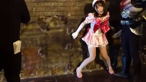 Asian nurse in industrial setting fights and poses