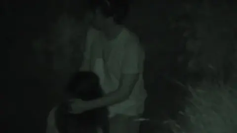 Two Men Intimate in Grass Field