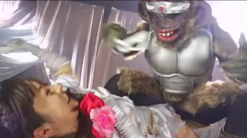 Asian Duo in Costumes Share Intimate Moment